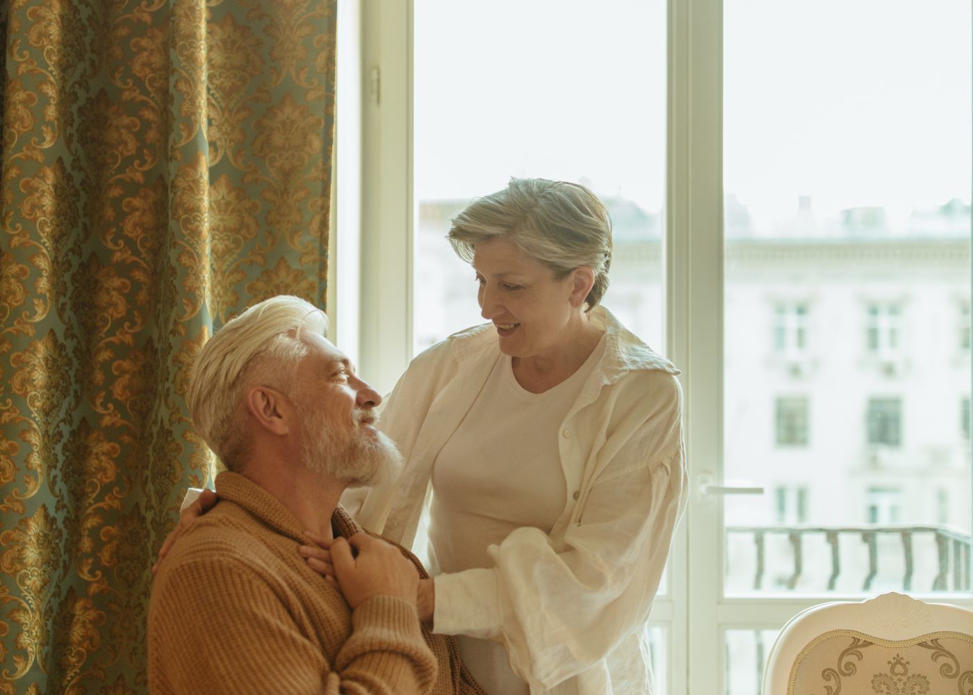 An older couple smiling together at home