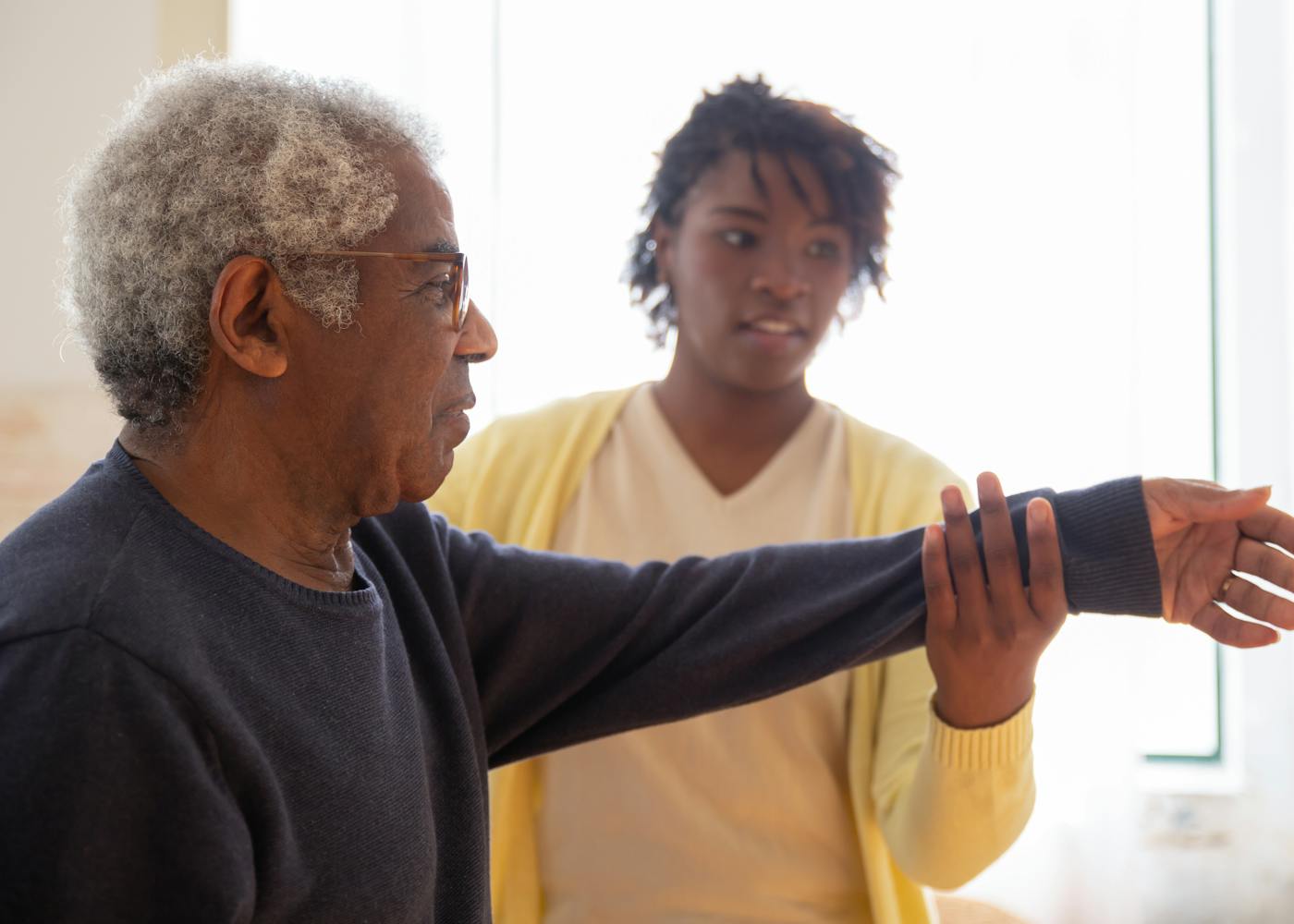 A caregiver helping a senior with gentle daily movement