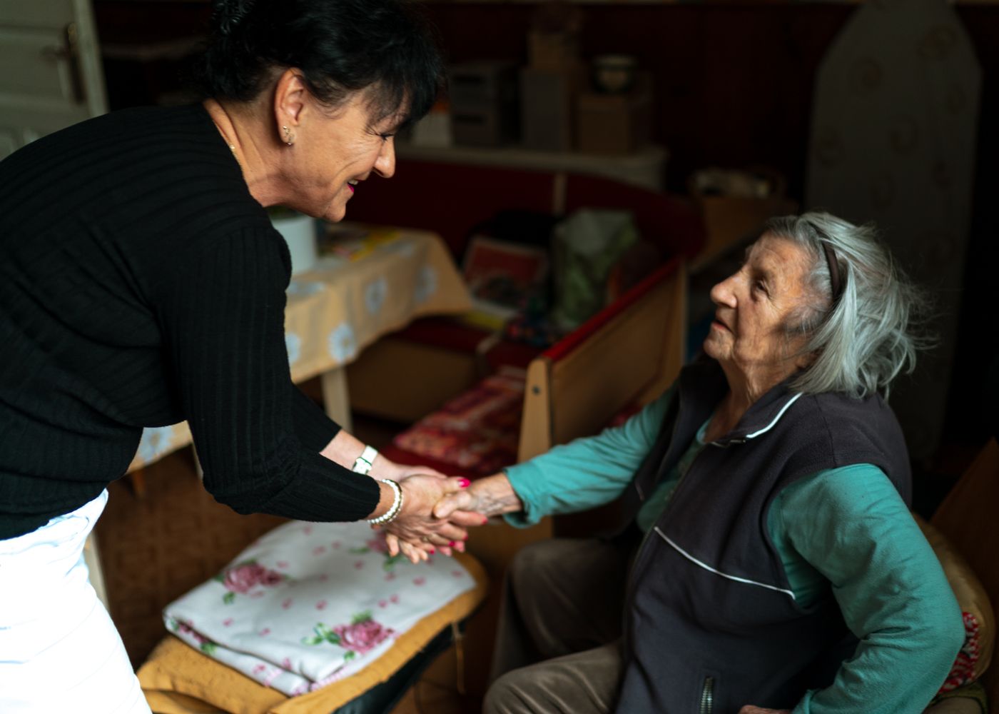 A God's Hand caregiver greeting a senior client with warmth